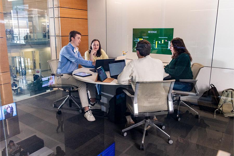 A group of students around a conference table